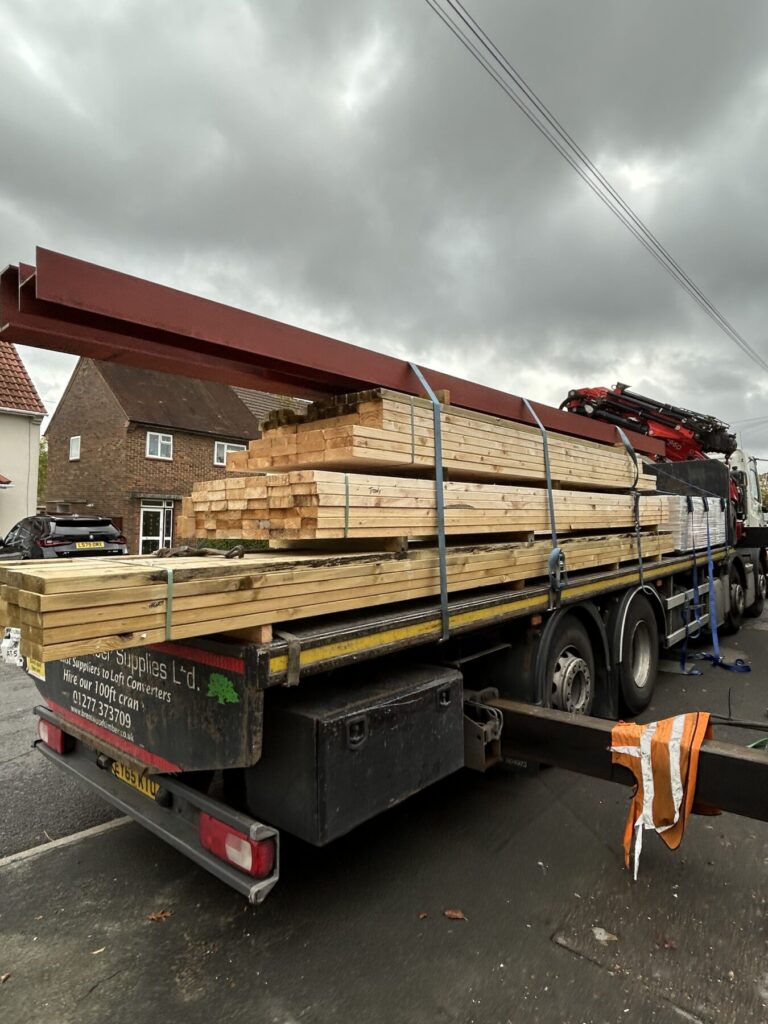 Structural materials delivered for a loft conversion project, including timber beams and steel supports for safe and efficient construction work.